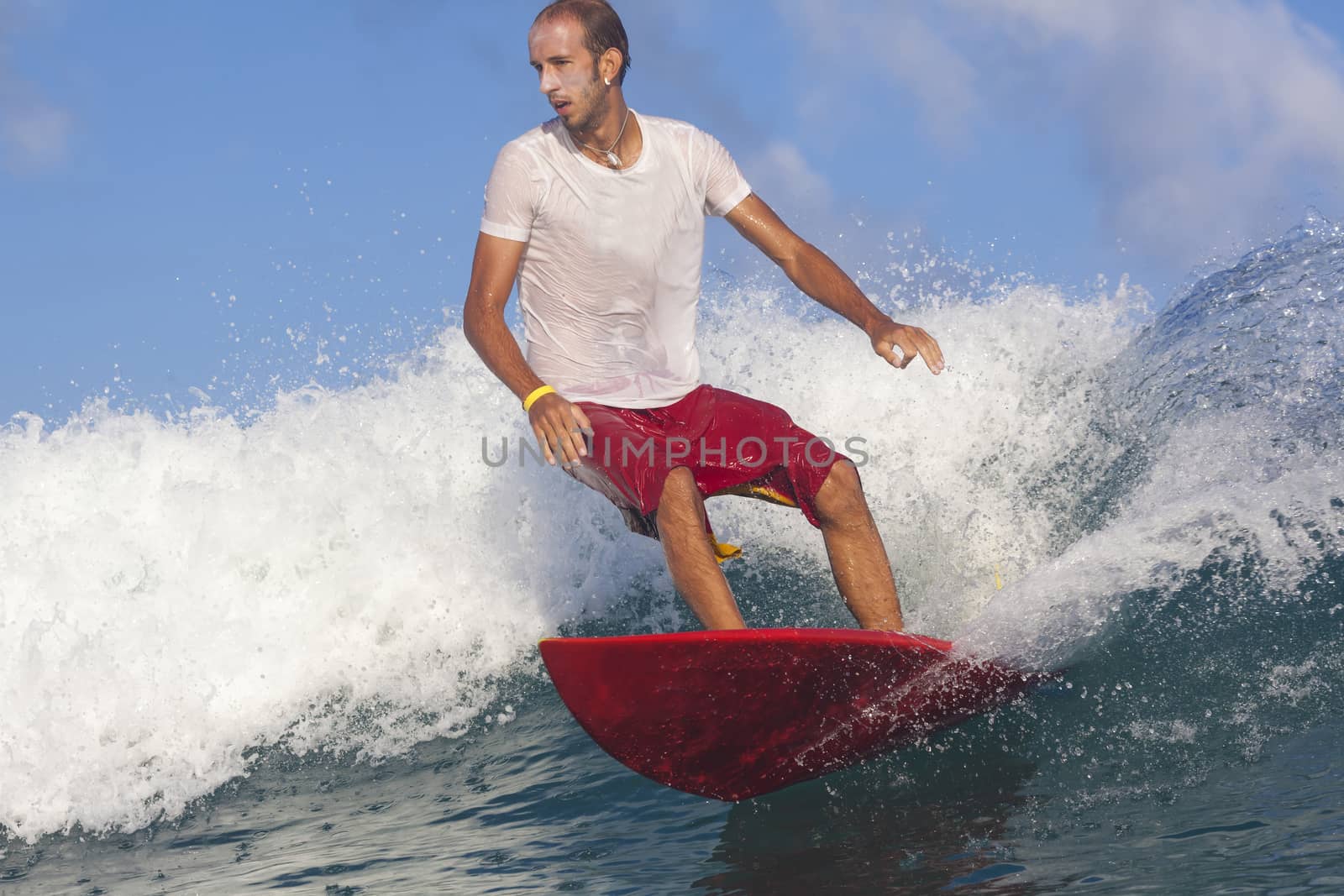 Surfer on Amazing Blue Wave, Bali island.