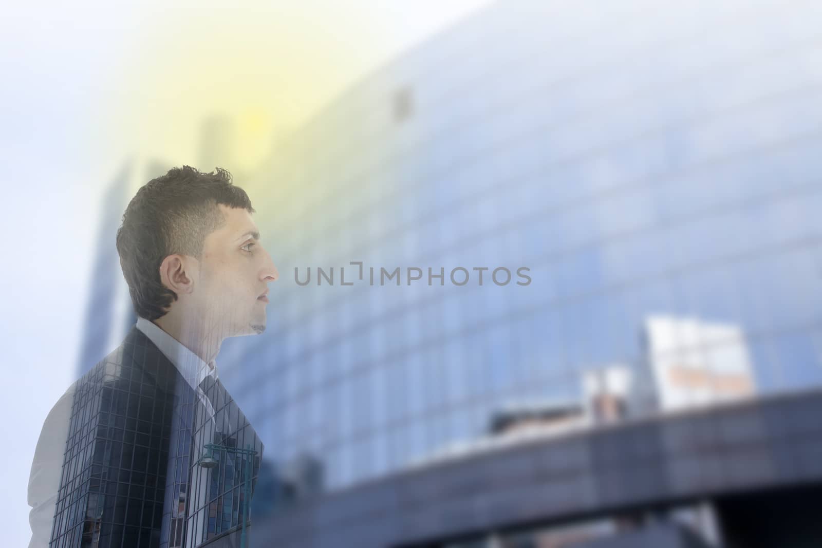 Double exposure of business man with office building