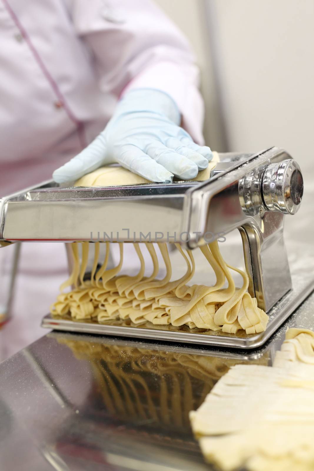 A chef is preparing handmade fresh pasta fettuccine and ravioli