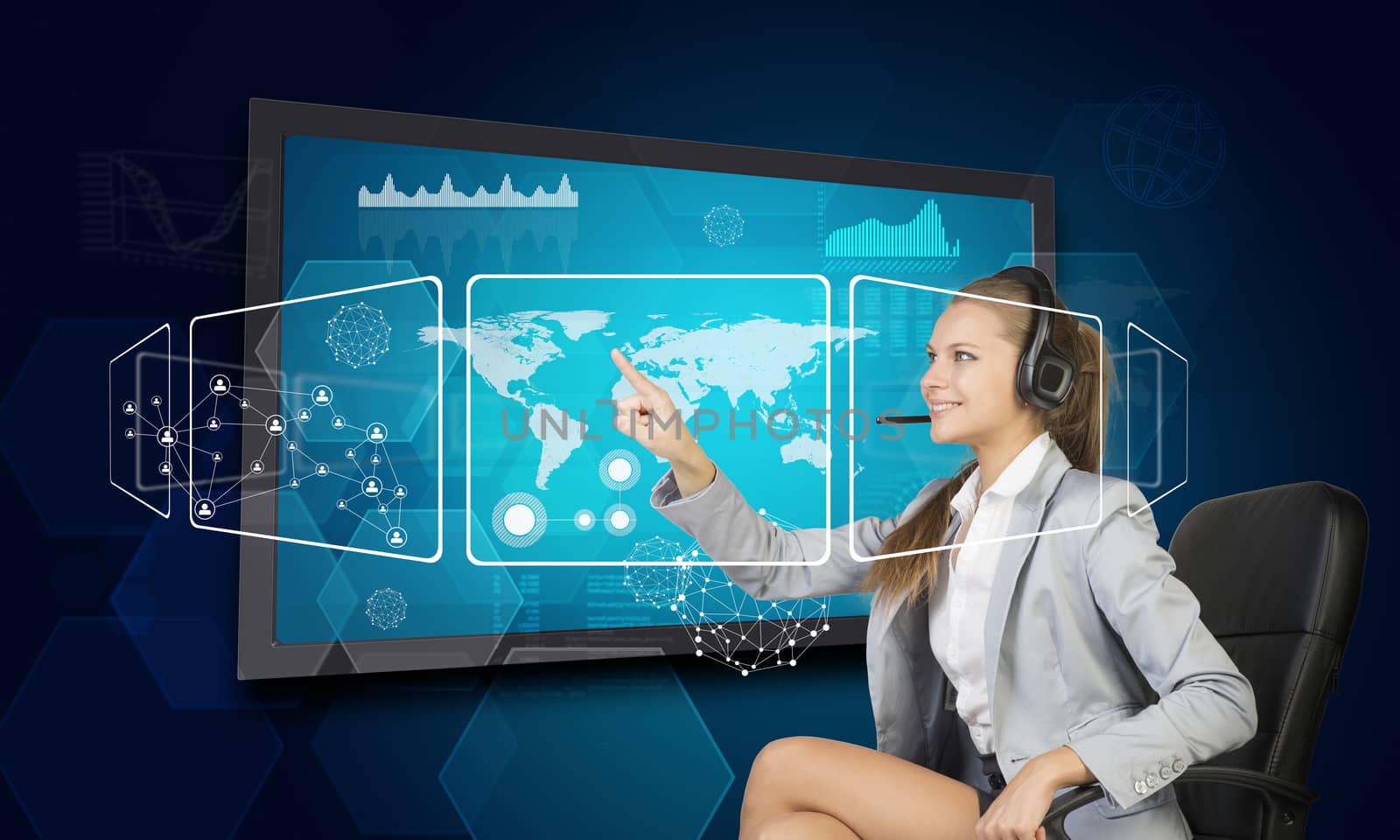Businesswoman in headset using touch screen interface with world map, graphs and other elements, on blue background