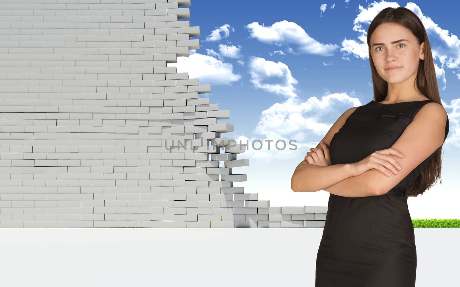 Thoughtful businesswoman in dress with crossed arms looking at camera. Dilapidated brick wall, green meadow and sky as backdrop. Concept of freedom