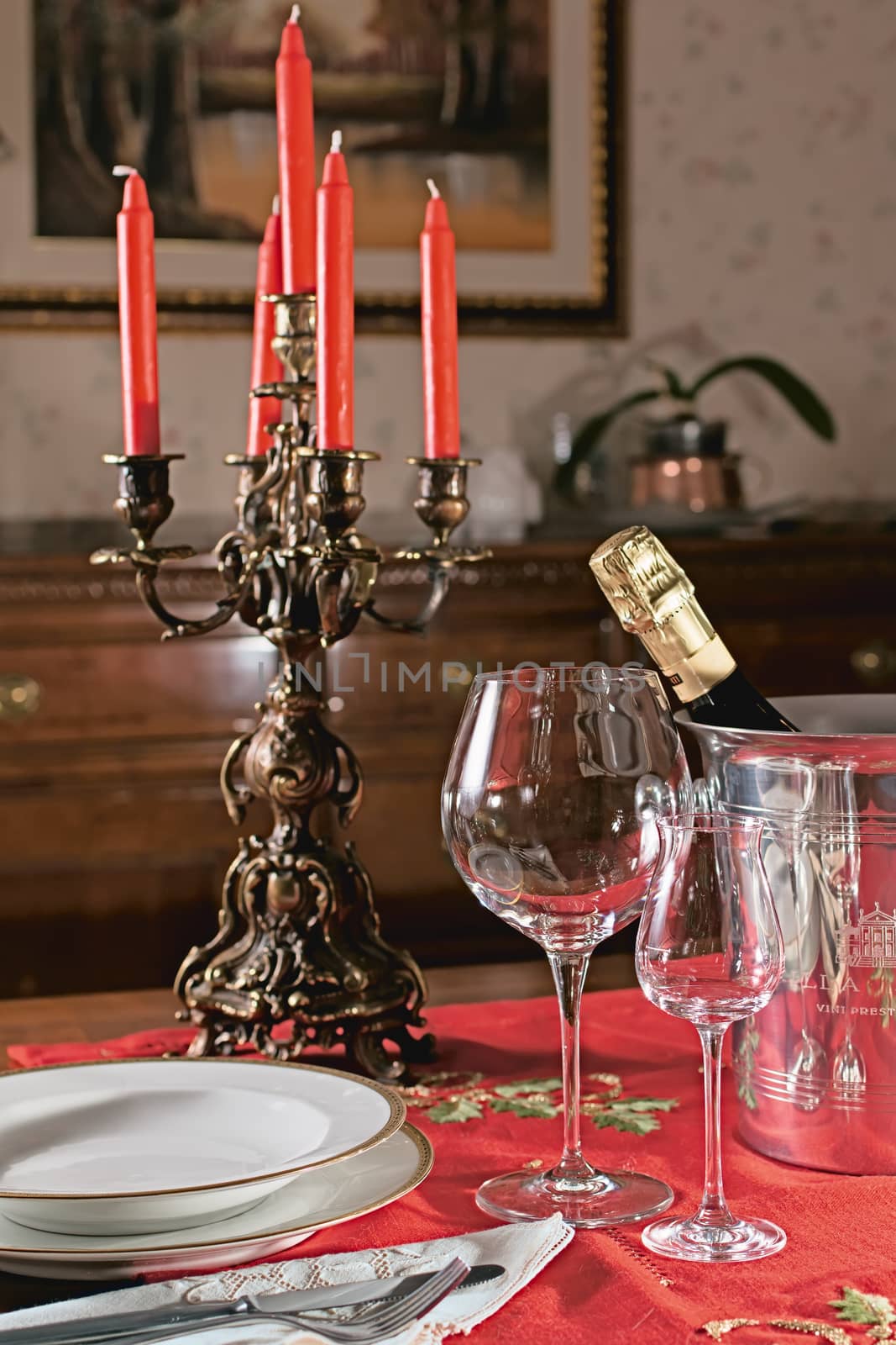 supper table with candlestick , glasses and plates