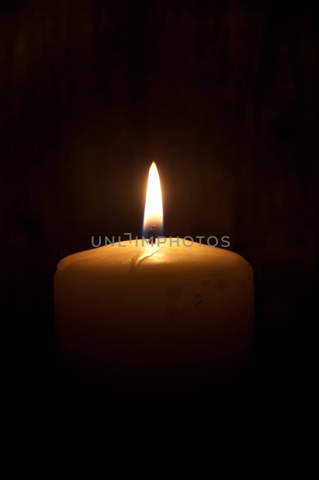 Single lit candle in the dark (also space for text)