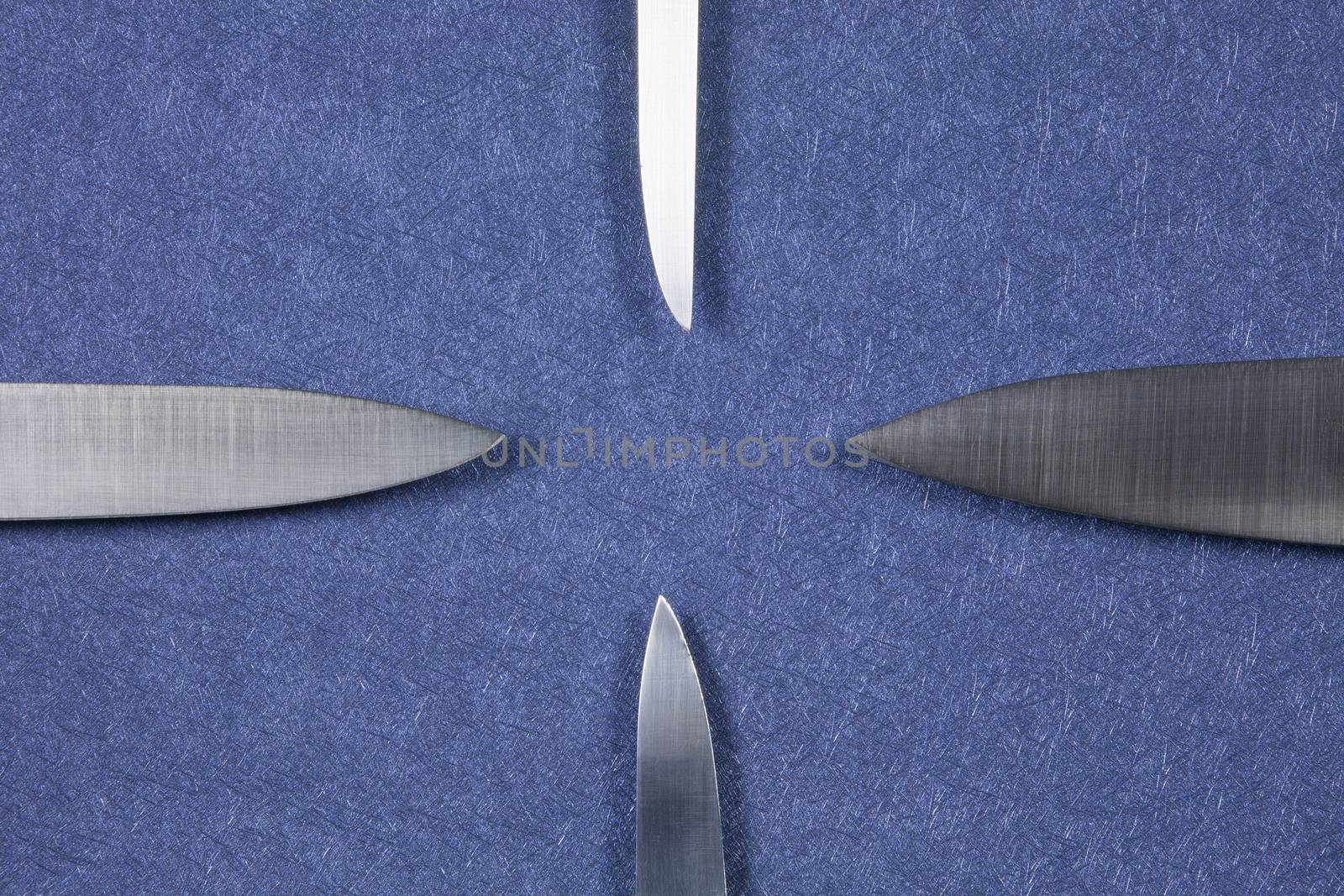 four big kitchen knife bright silver blades on blue background