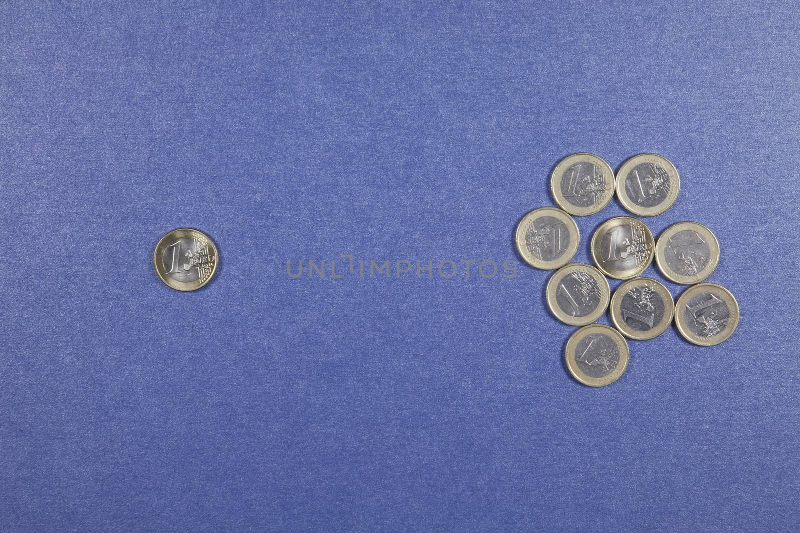 One Euro coins in two groups on blue background