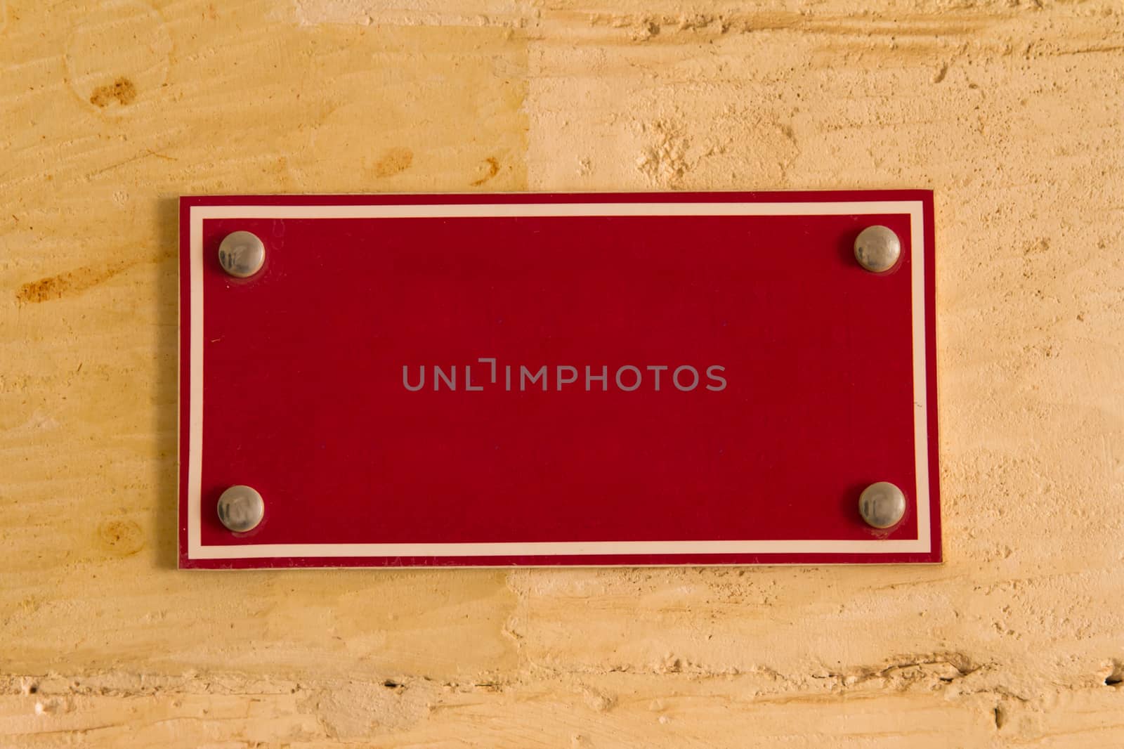 Blank red board sign with space on wall for your designs.