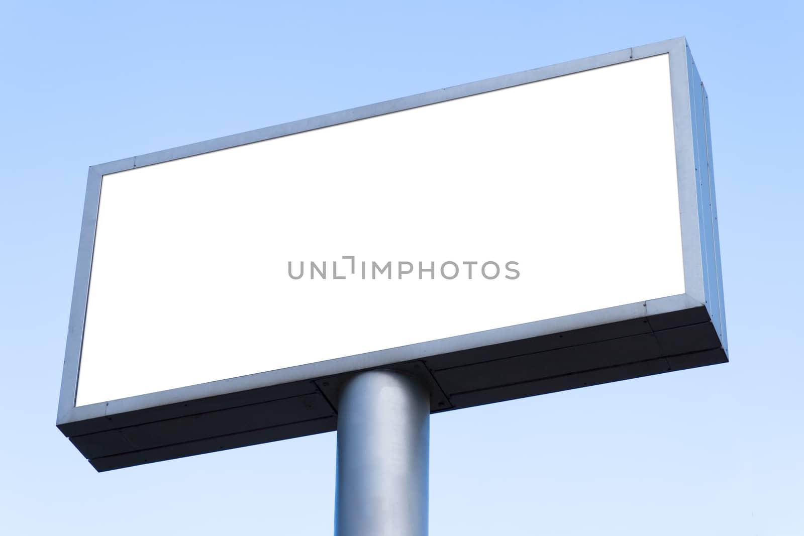 Big blank billboard with clear blue sky.