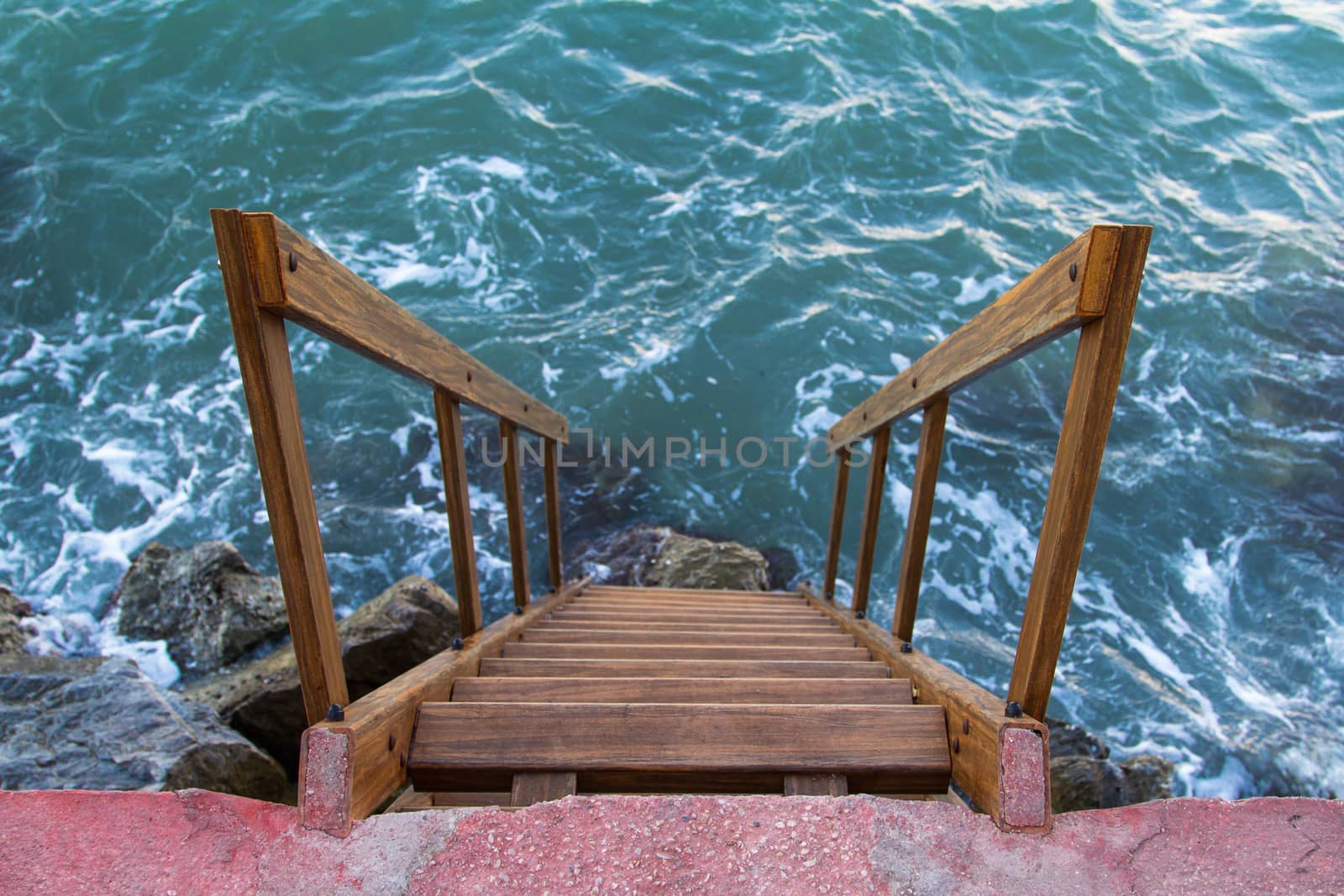 Wavy sea and stairs at the coast.