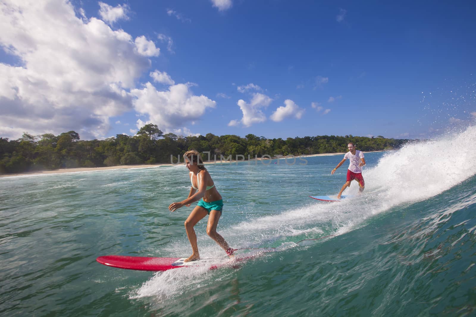 Surfer girl on Amazing Blue Wave, Bali island.