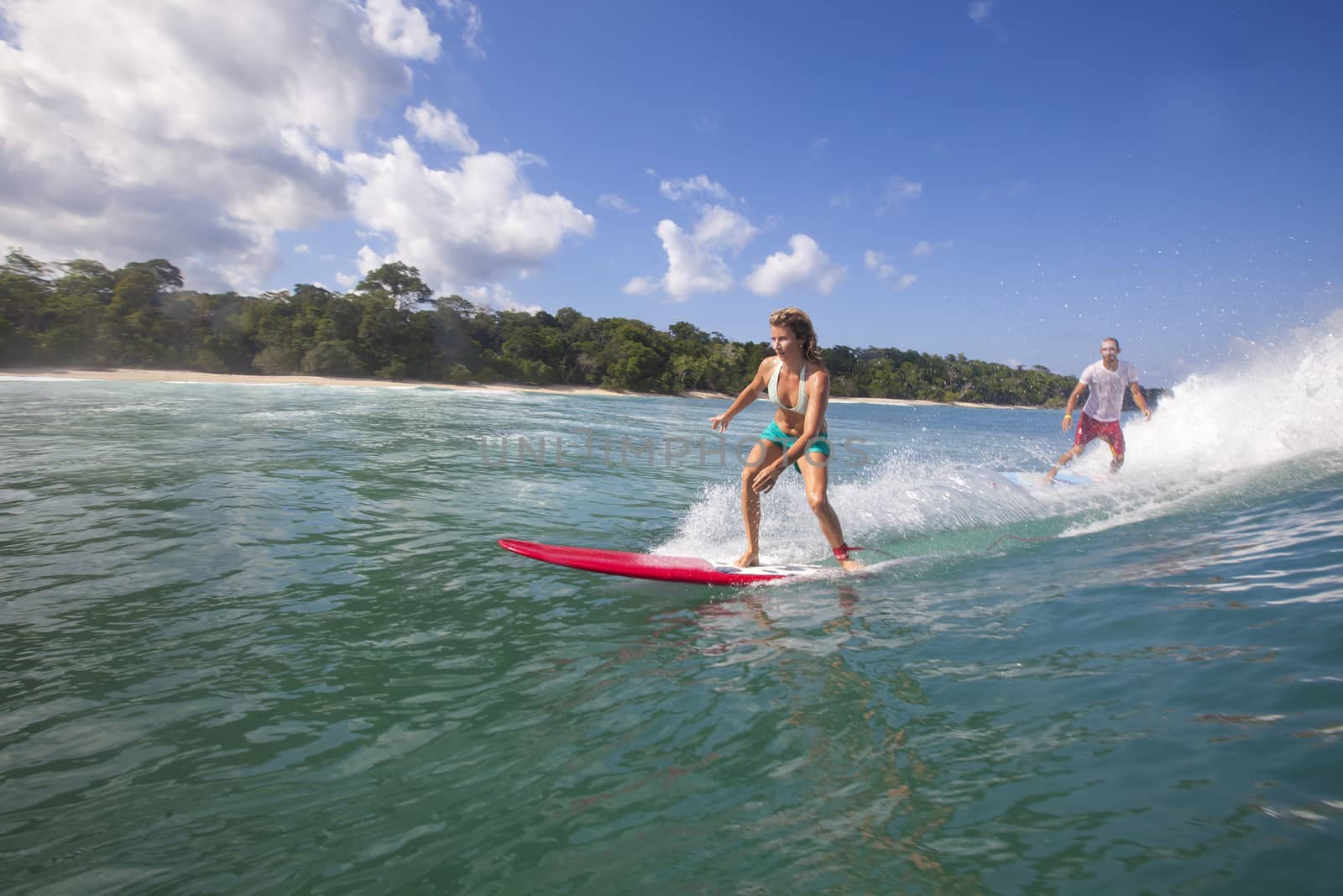 Surfer girl on Amazing Blue Wave, Bali island.