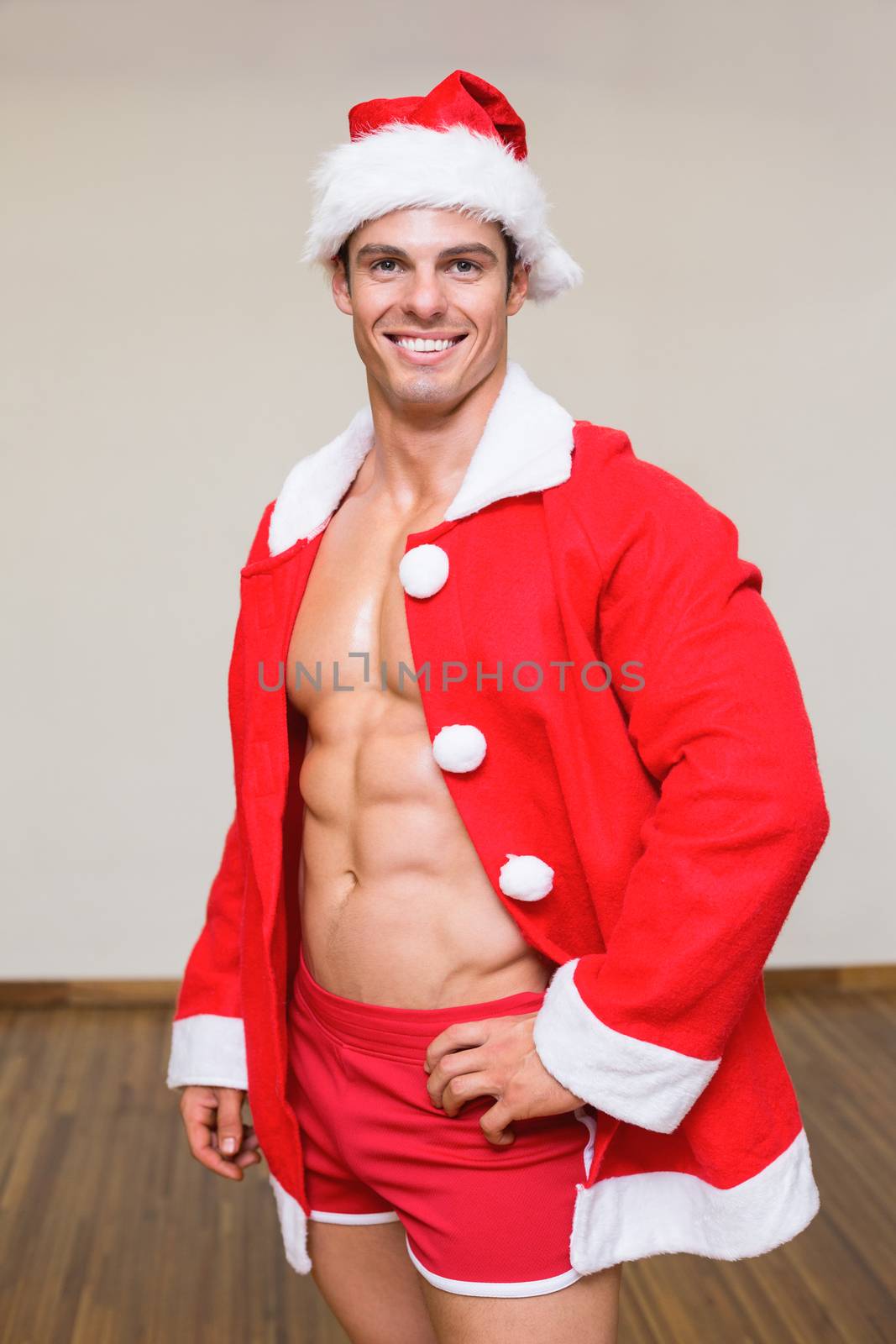 Portrait of macho man in santa costume at the gym