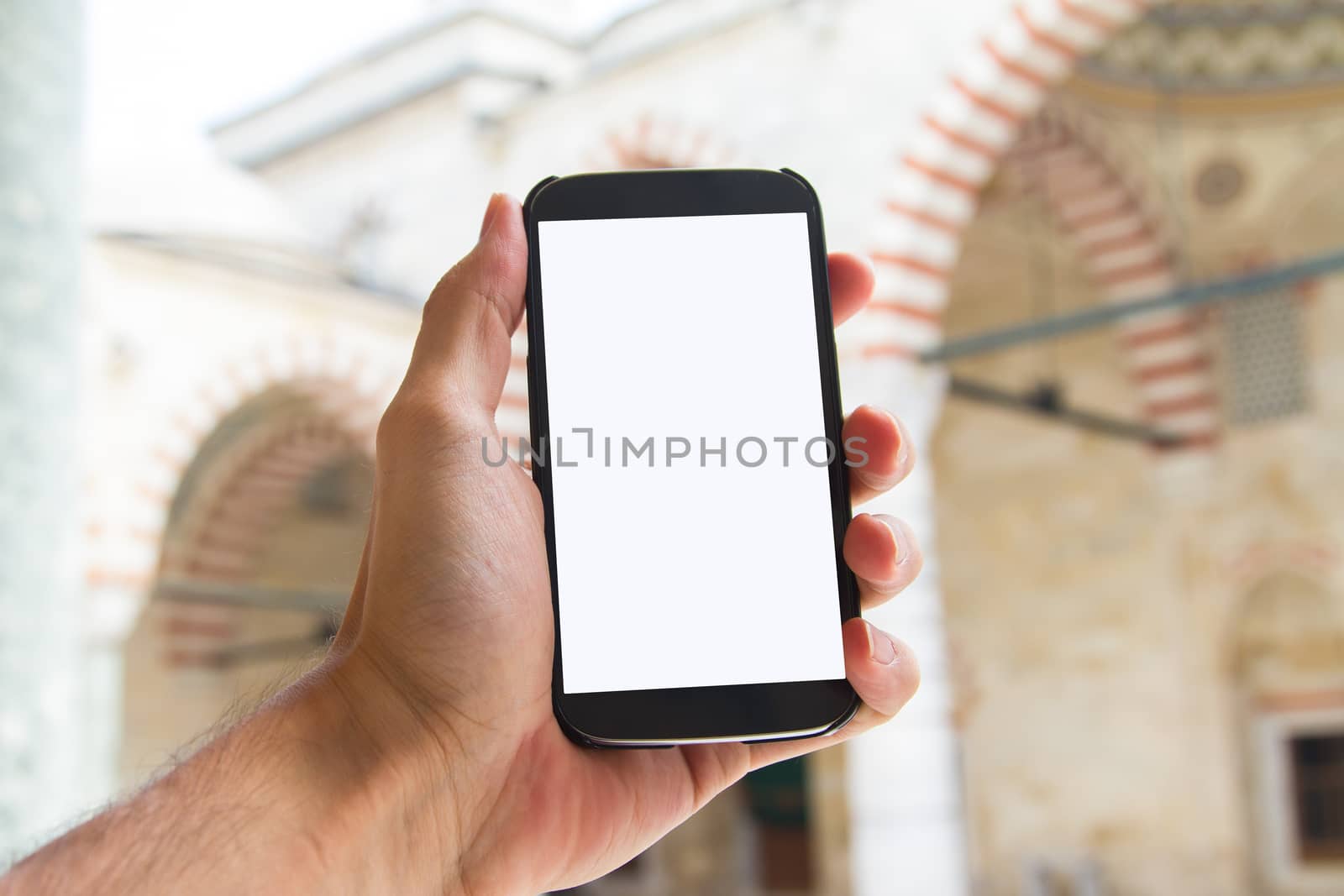 Hand Holding Smart Phone in Mosque by niglaynike