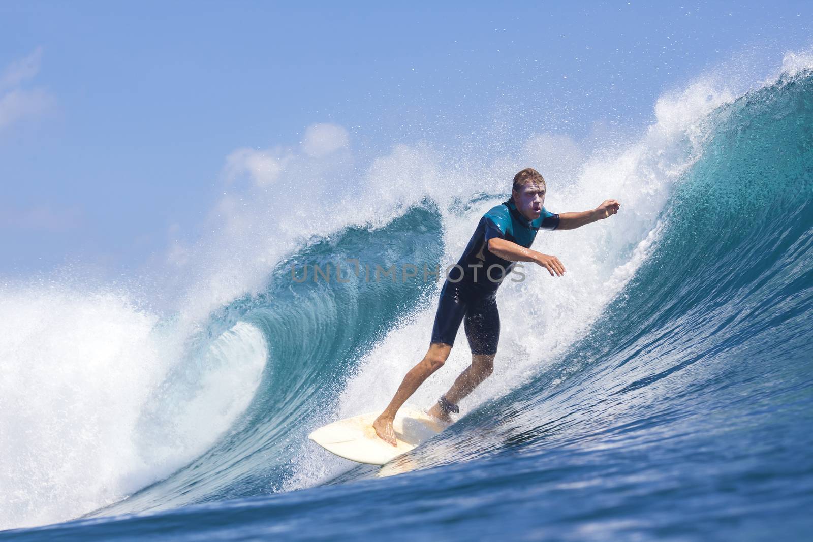 Surfer on Amazing Blue Wave, Bali island.