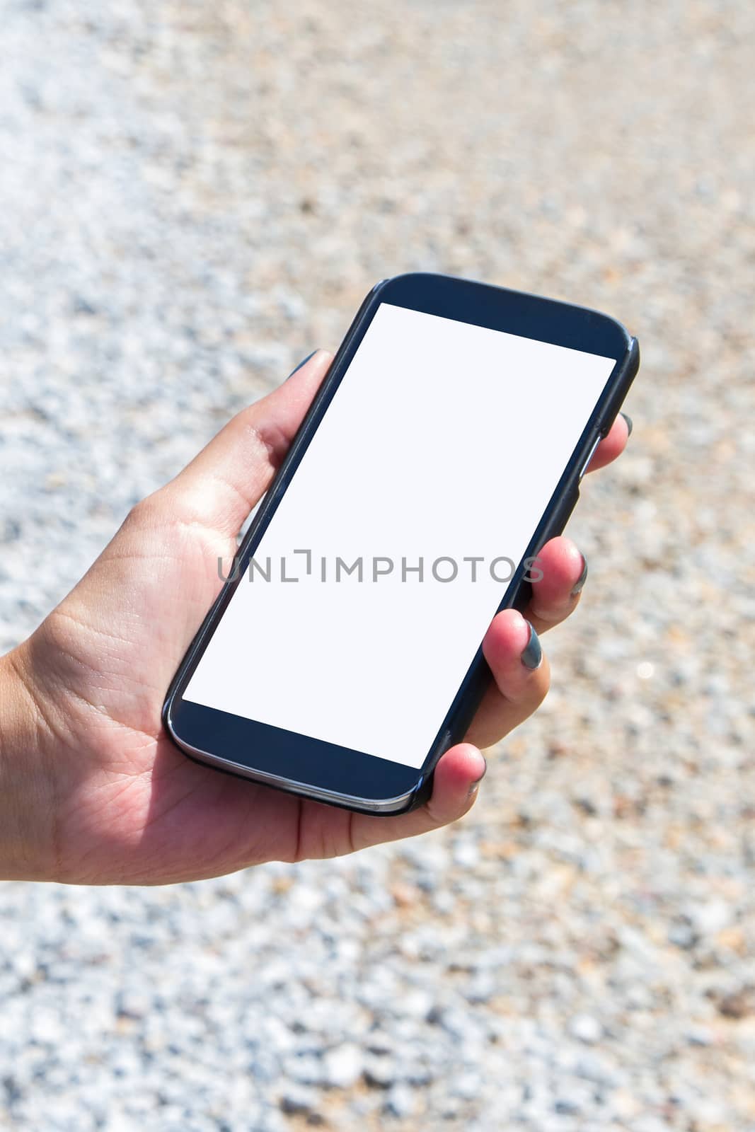 Female hand holding mobile phone with white blank screen mock up, copy space.
