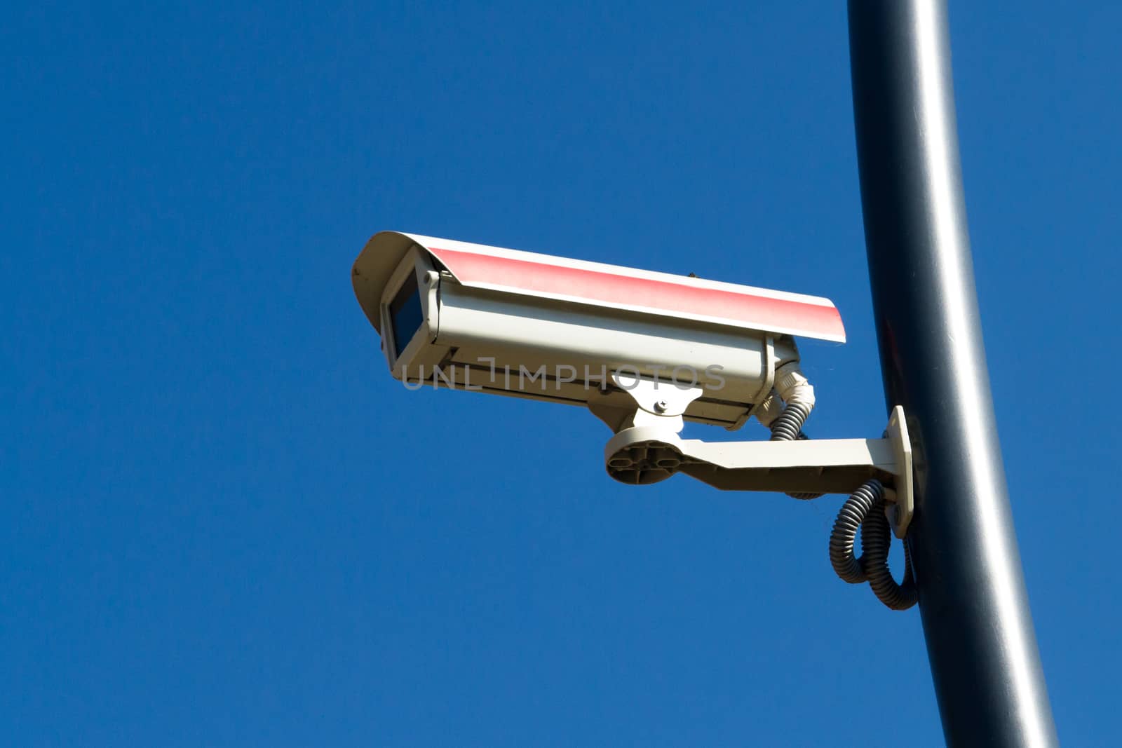 Security camera on blue sky.