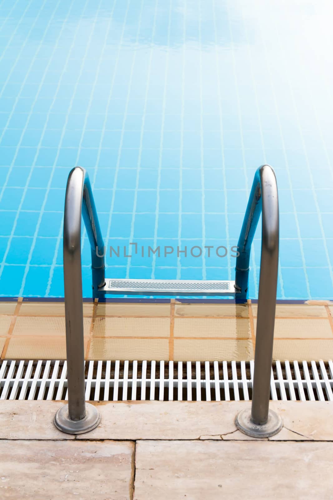 Back view of stair of blue swimming pool.