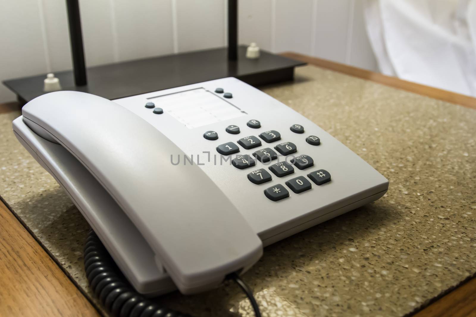 Telephone for customer service on table in hotel room.