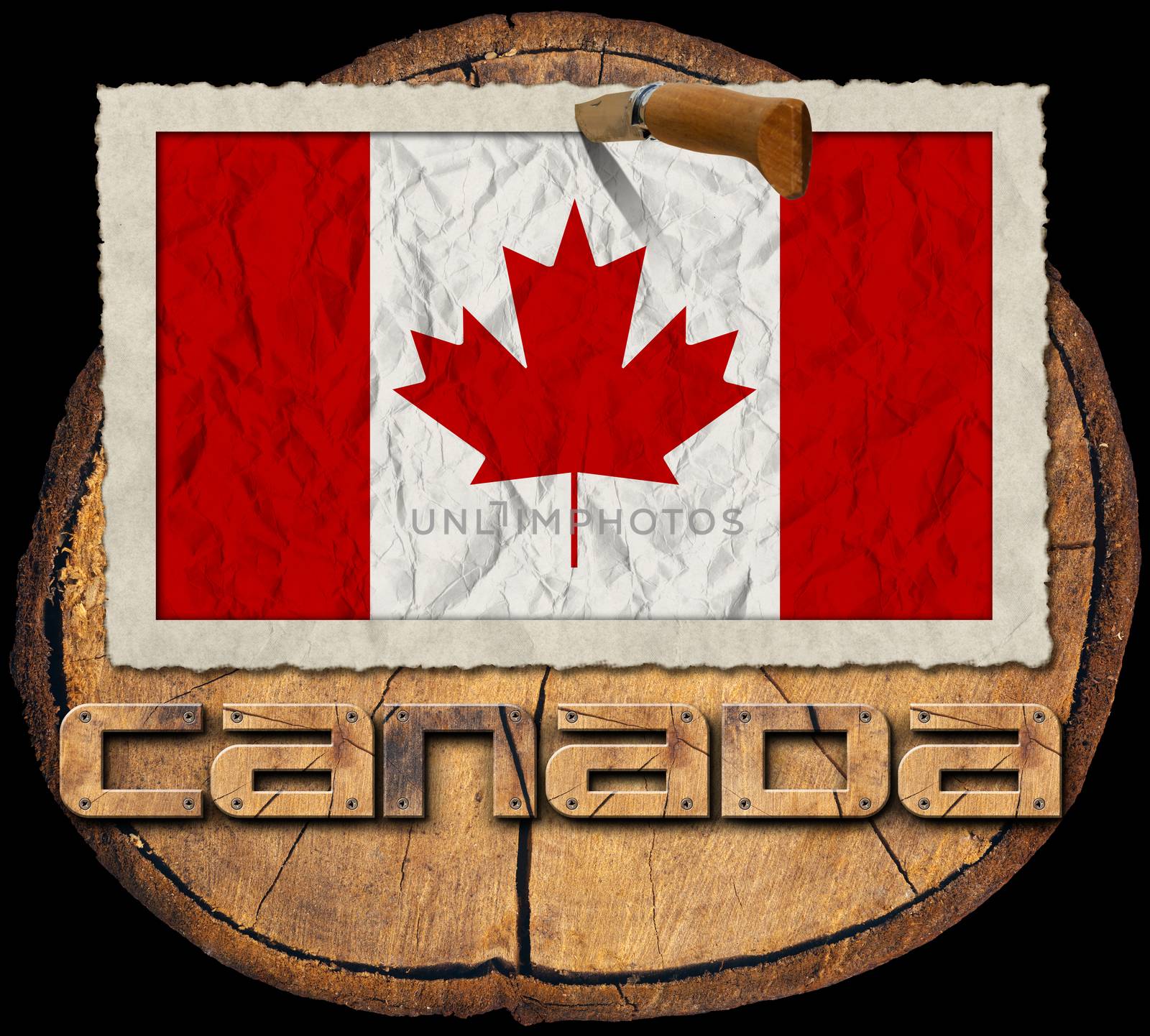 Flag of Canada in a old photo frame with wooden text canada on a section of tree trunk isolated on black background