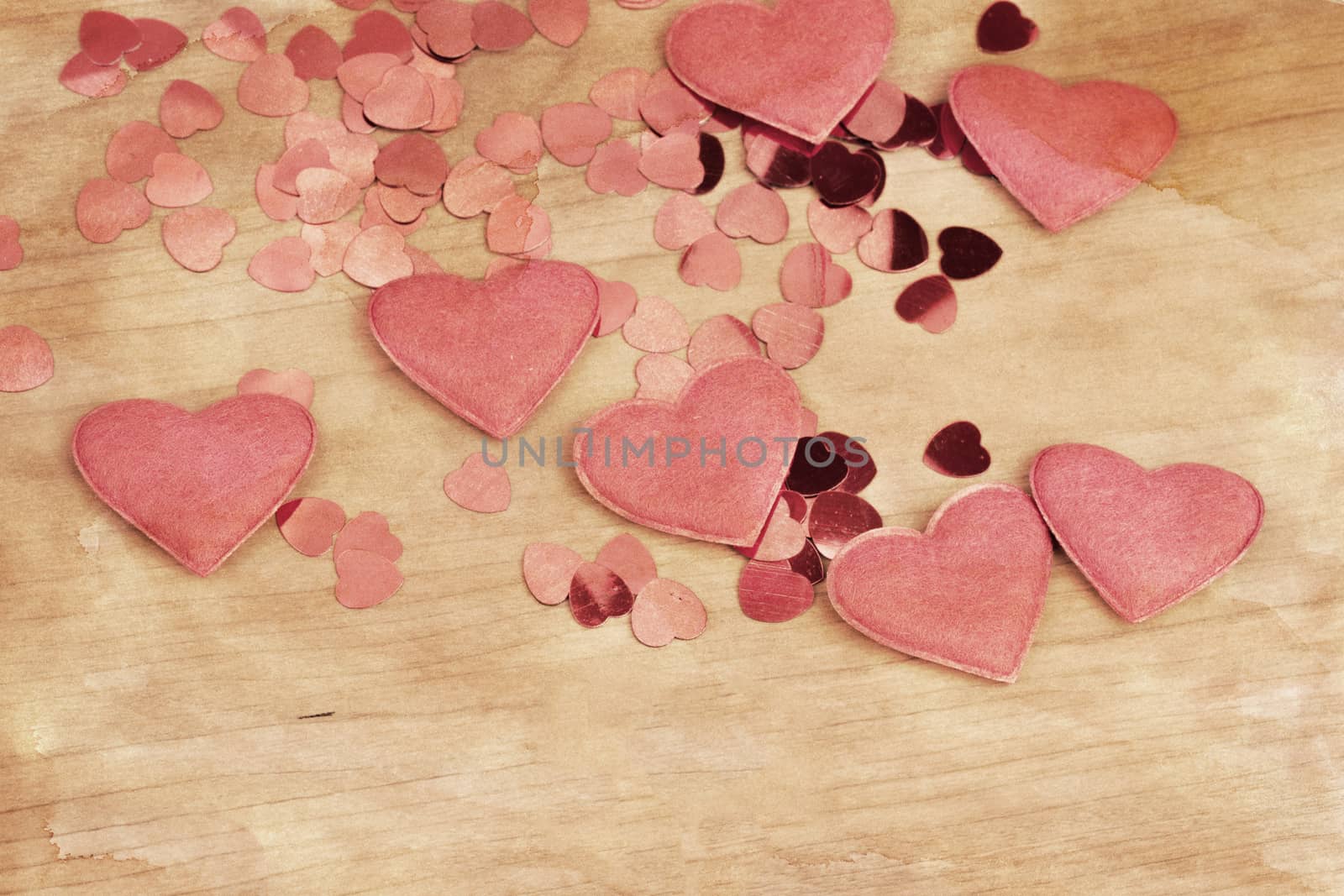 valentine's wooden and confetti hearts on a wooden background , valentine's day , retro color tone