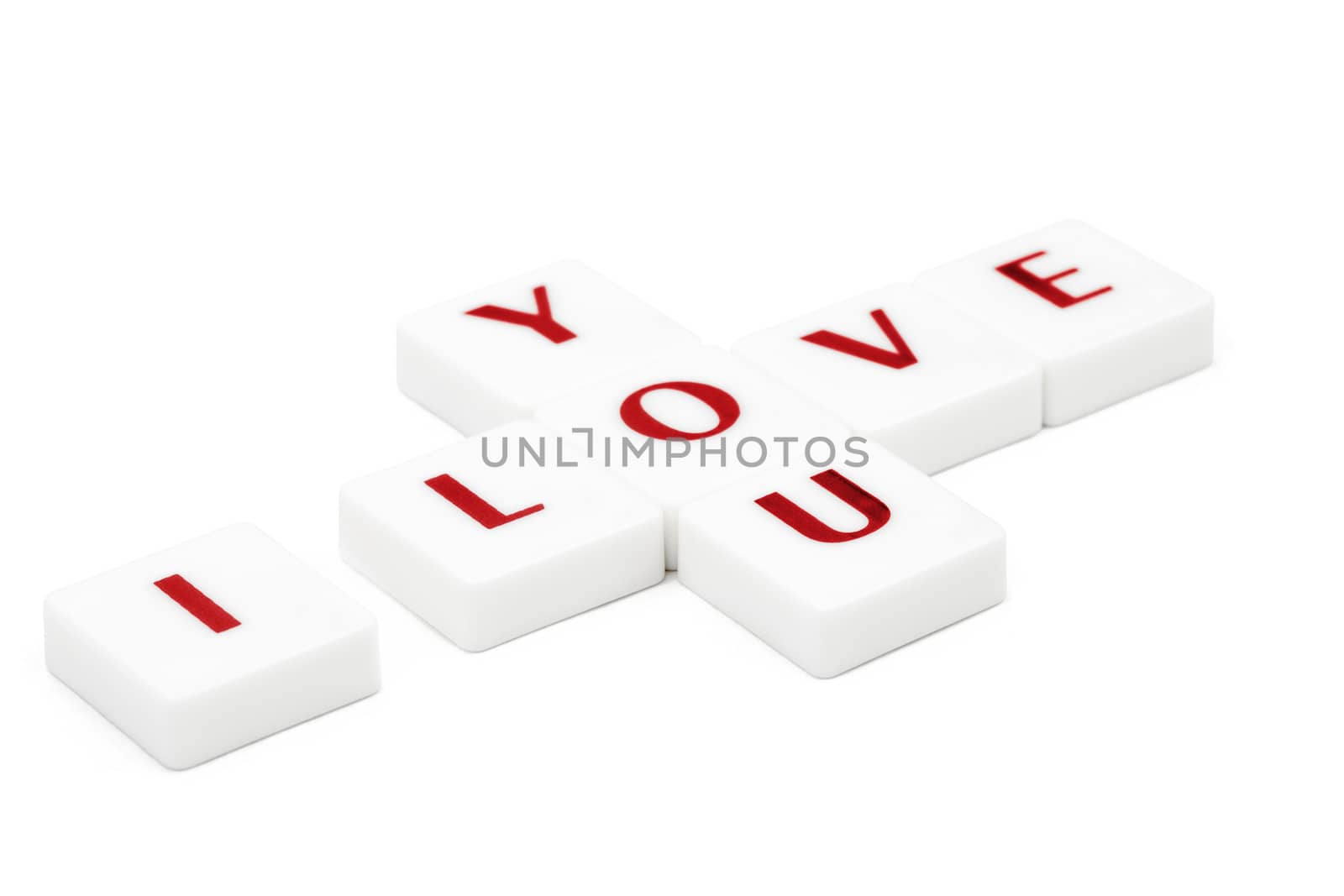Valentine concept. Scrabble letters spelling I love you isolated on white