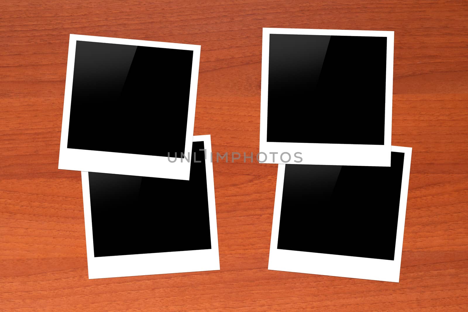 Blank, black picture frames with copy space on wooden table.