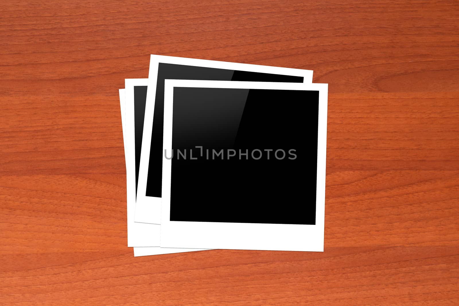 Blank, black picture frames with copy space on wooden table.