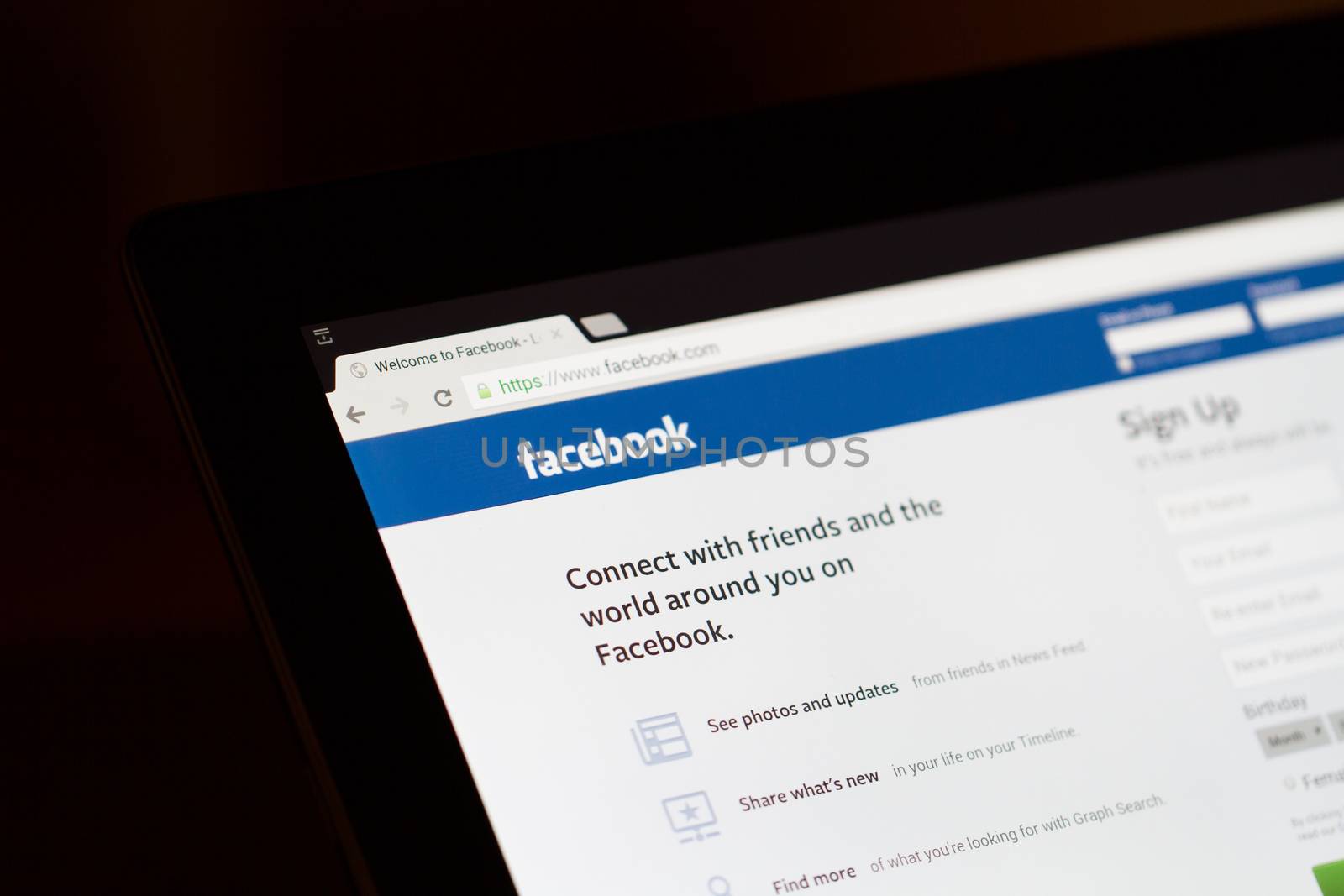 ISTANBUL, TURKEY - MARCH 16, 2013: Photo of Facebook.com home page on tablet. Facebook is the largest social media network and owned by Facebook, Inc.