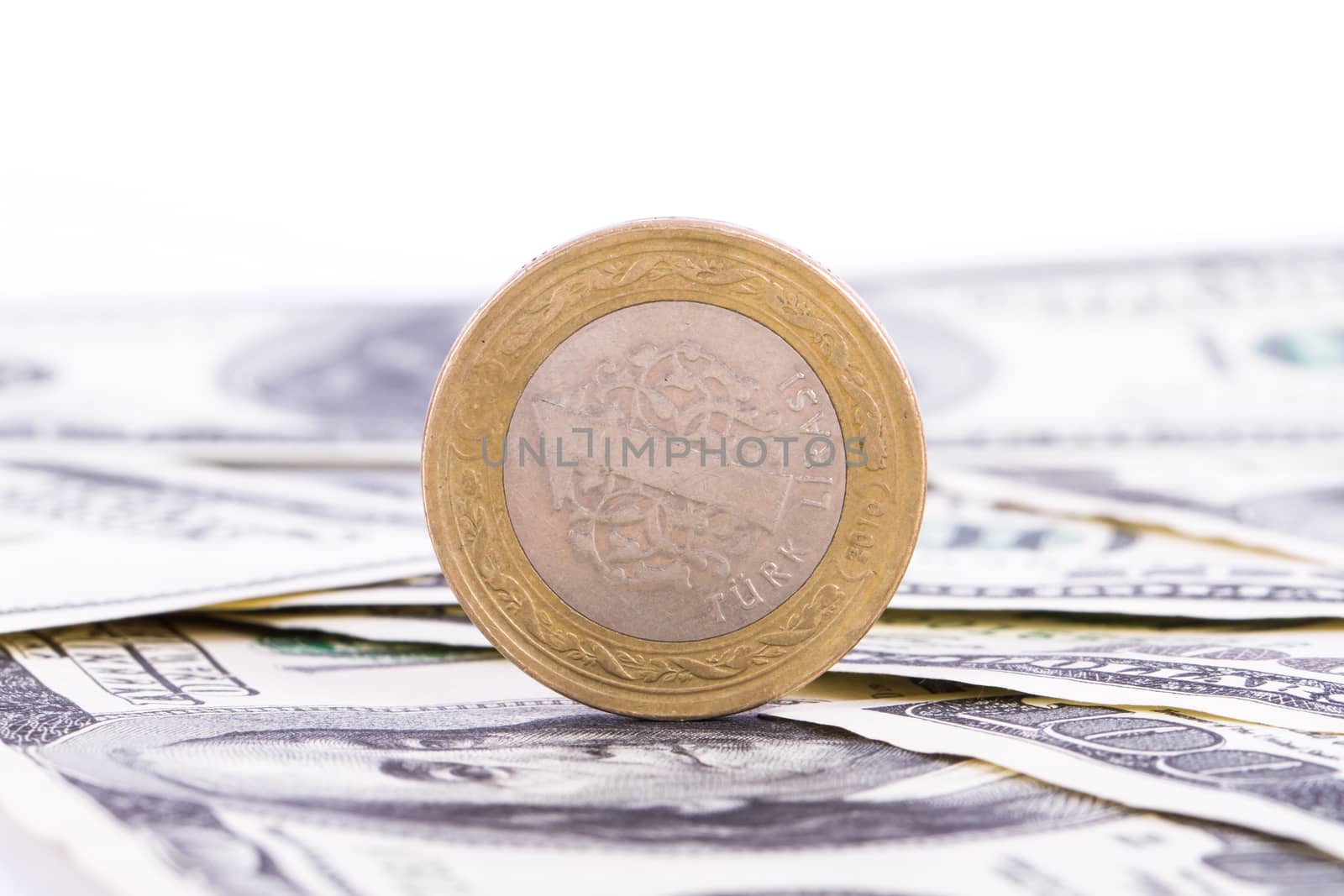 One hundred dollar banknotes and coin, isolated on white background.