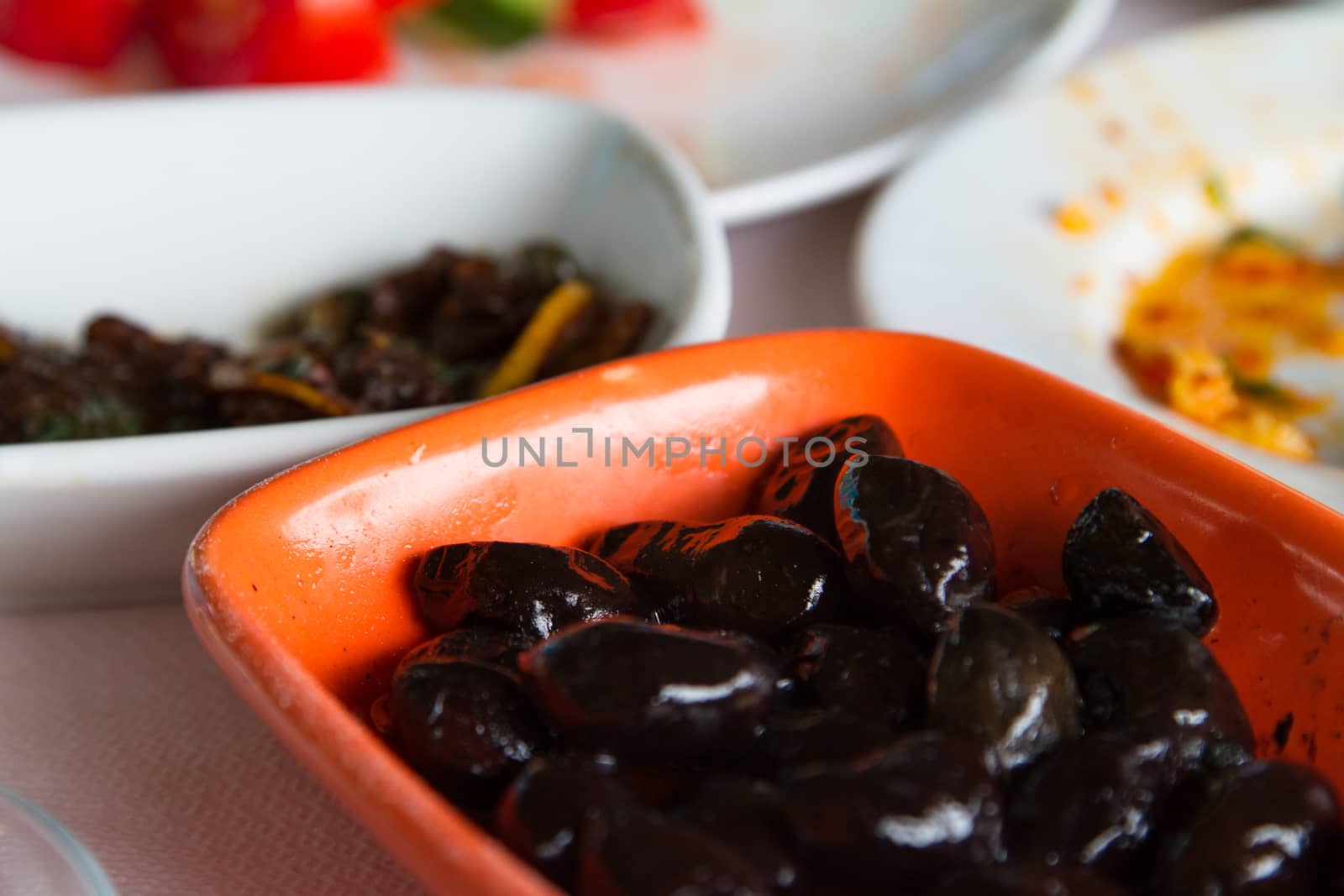 Breakfast service, black olives on table.