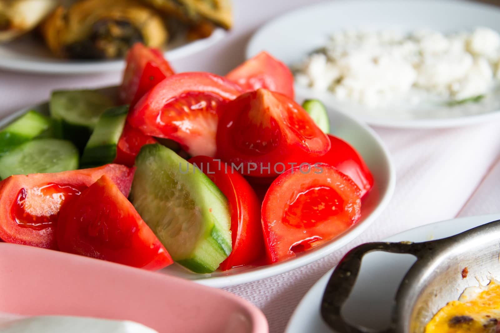 Breakfast service, salad in white plate.