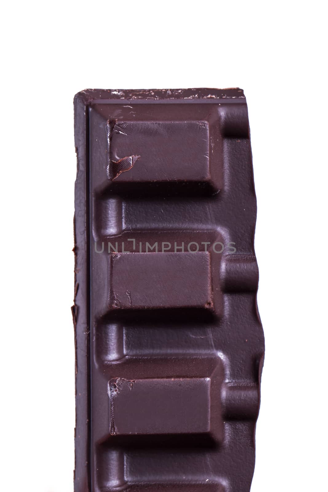 Broken black milk chocolate bar piece, isolated on white background.