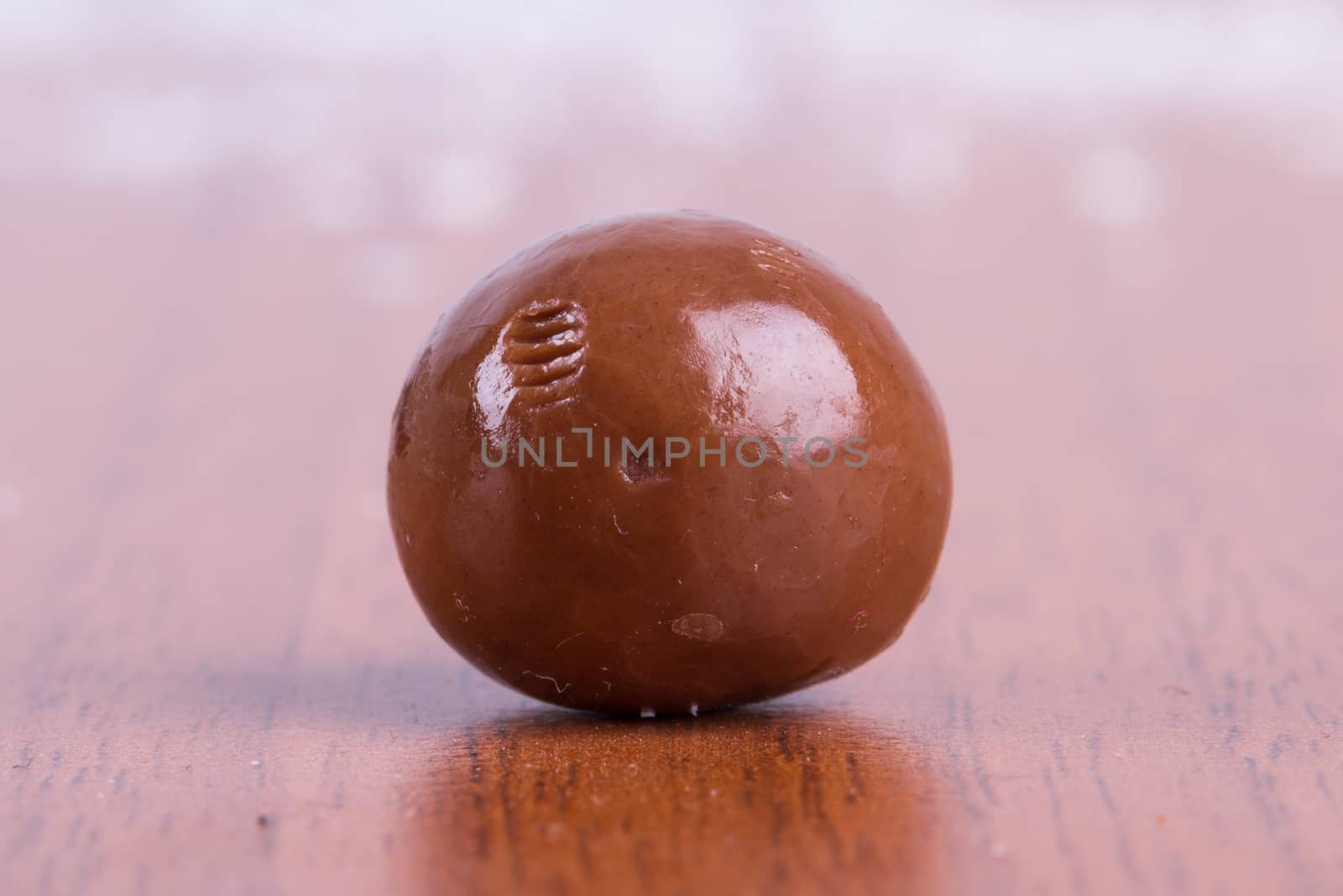 Single round milk chocolate candy.
