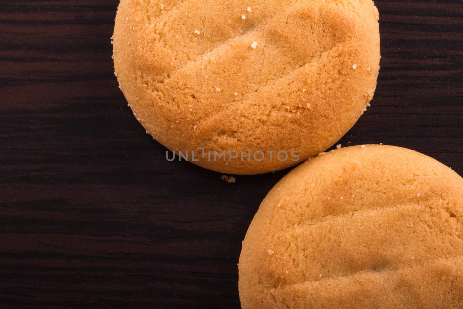 Close up and top view of biscuit cookies on wooden table.