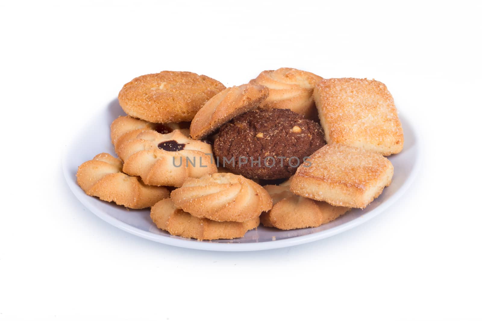 Delicious biscuit cookies on plate, isolated on white background.