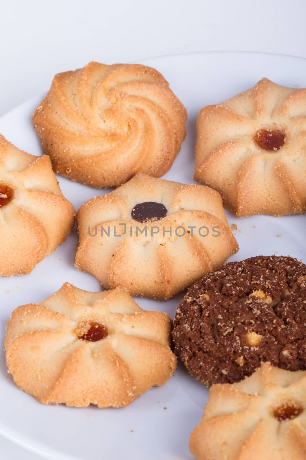 Heap of cookie chips on white.