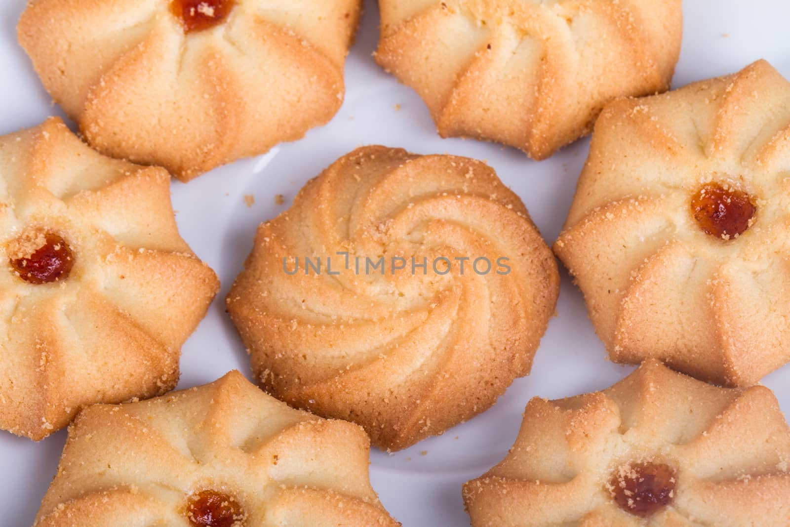Heap of cookie chips on white.