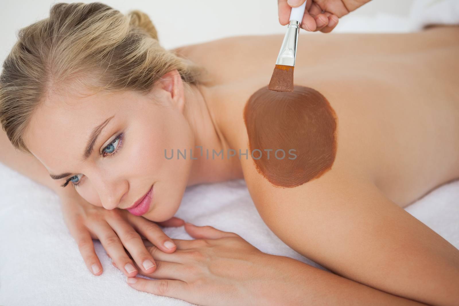 Beautiful blonde enjoying a chocolate beauty treatment at the health spa