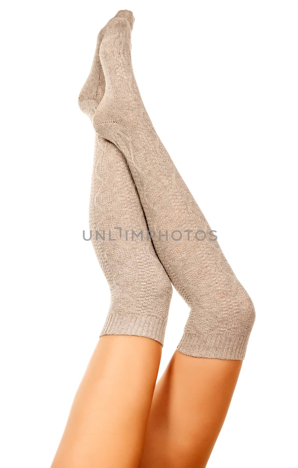 Female legs in knitted socks, white background, isolated