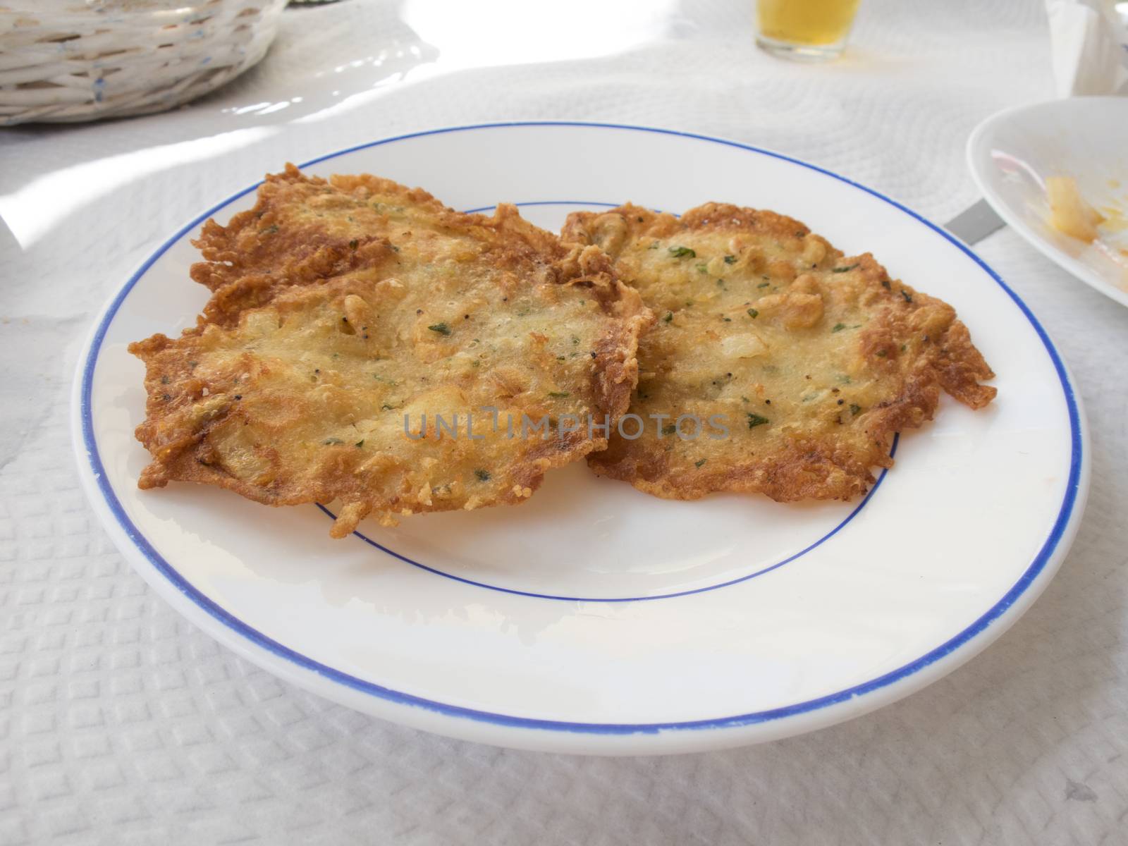 typical Andalusian little shrimp omelette fried in white dish on paper tablecloth restaurant Spain