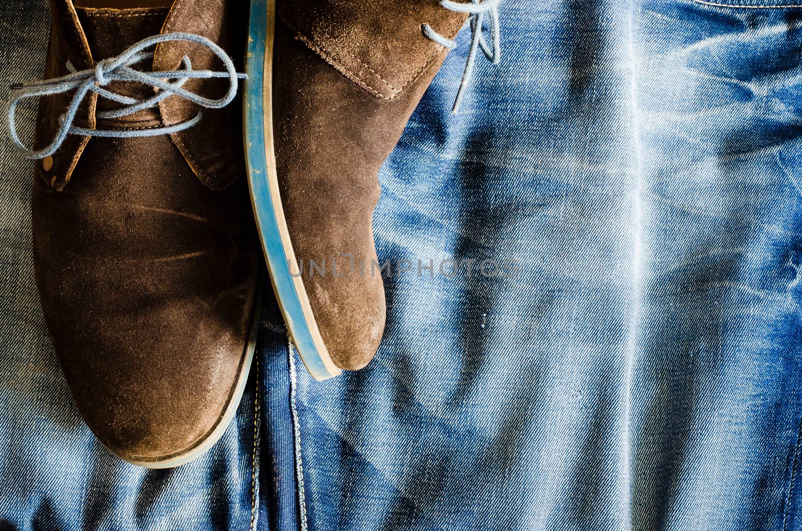 Detail of vintage leather shoes on denim fabric by martinm303