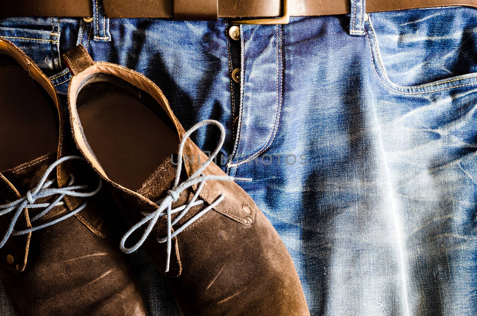 Detail of vintage style shoes on denim jeans