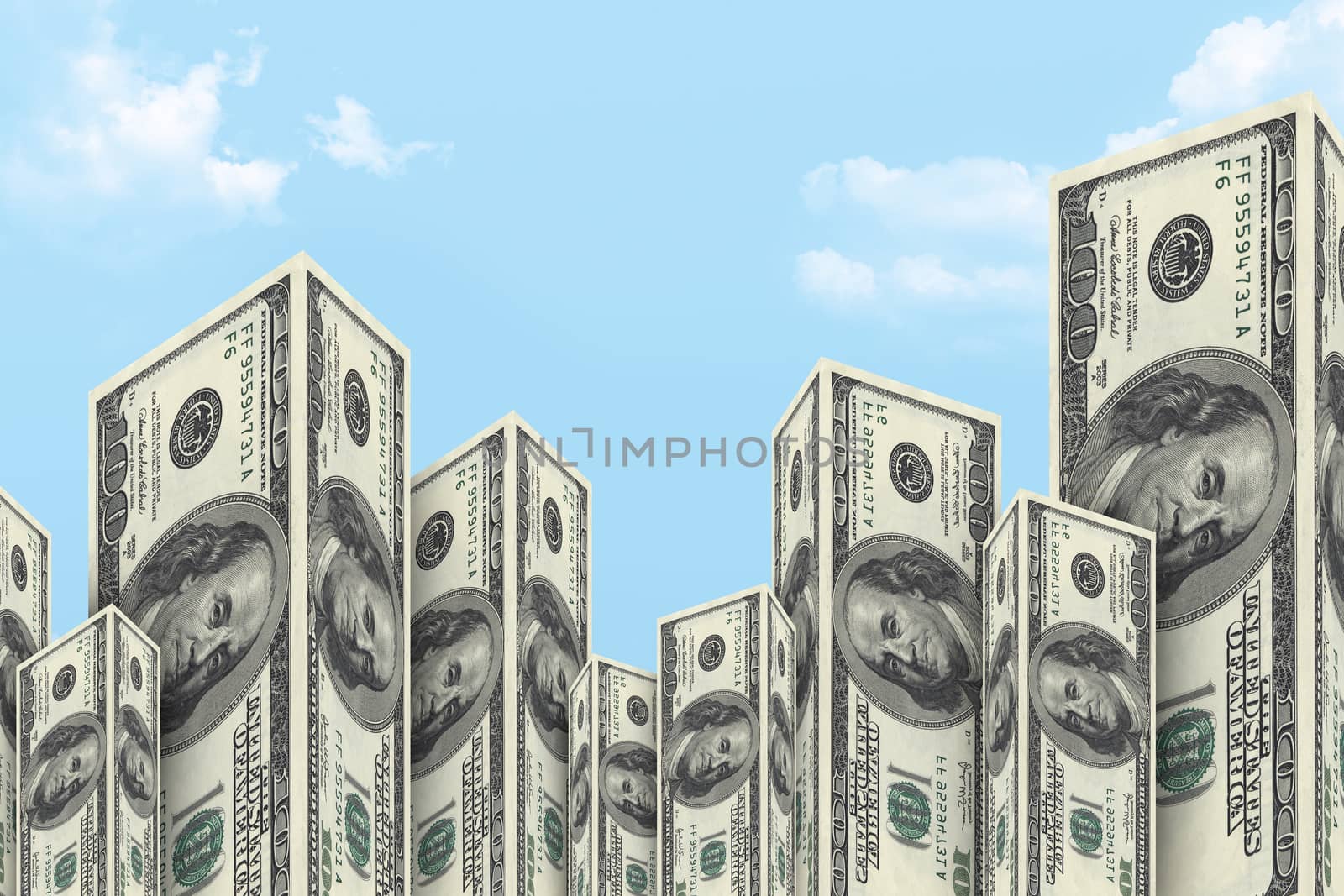 Skyscraper buildings made from one hundred dollar money banknotes on cloudy background.