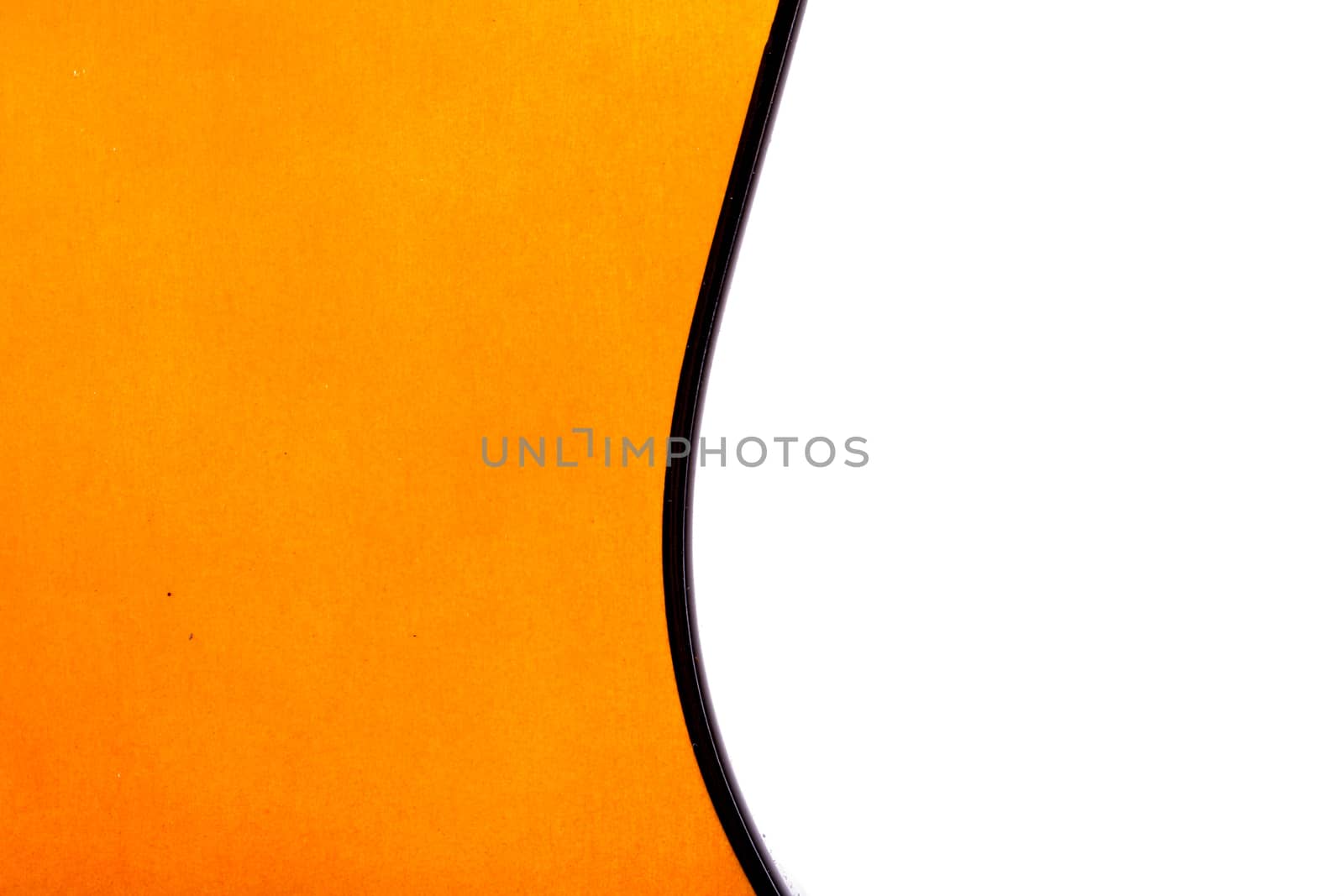 Detail view of orange wooden classical acoustic guitar, isolated on white background.