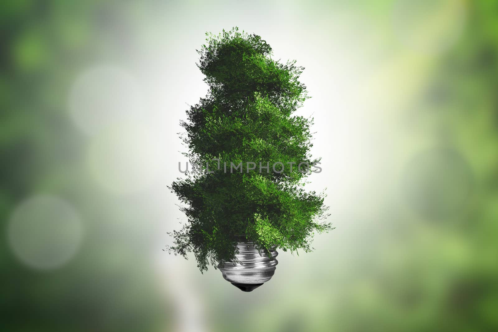 Ecology concept, light bulb with green tree growing on green blurry background.