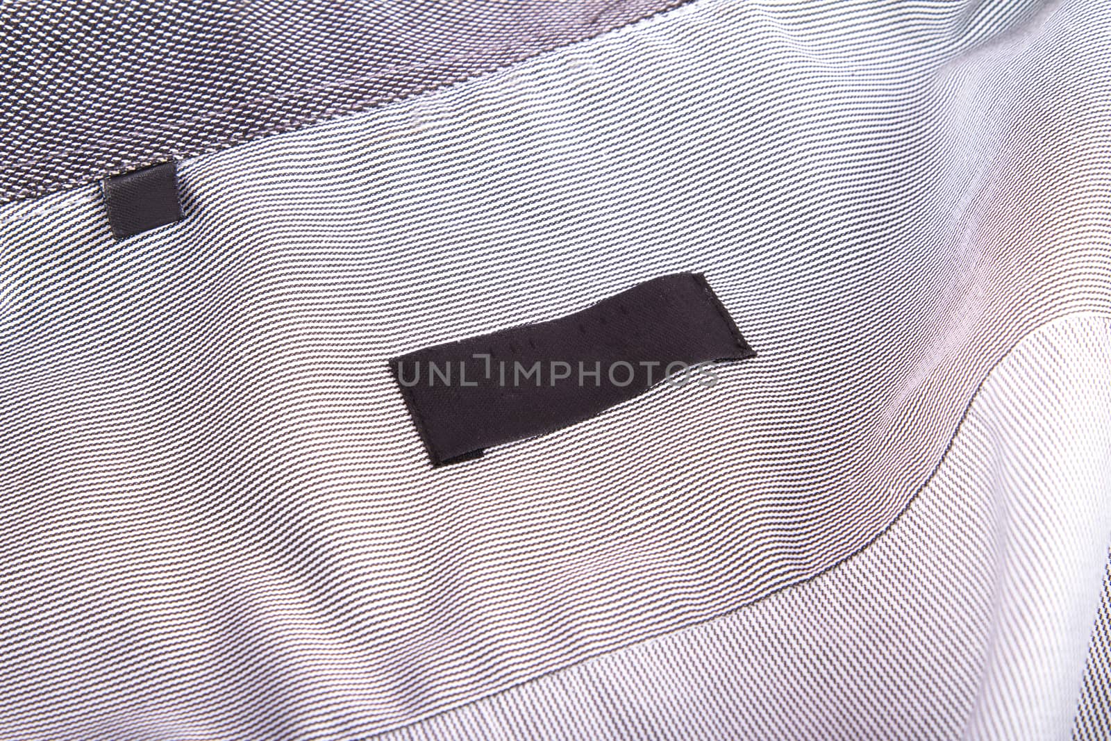 Close up view of blank black label in shirt.