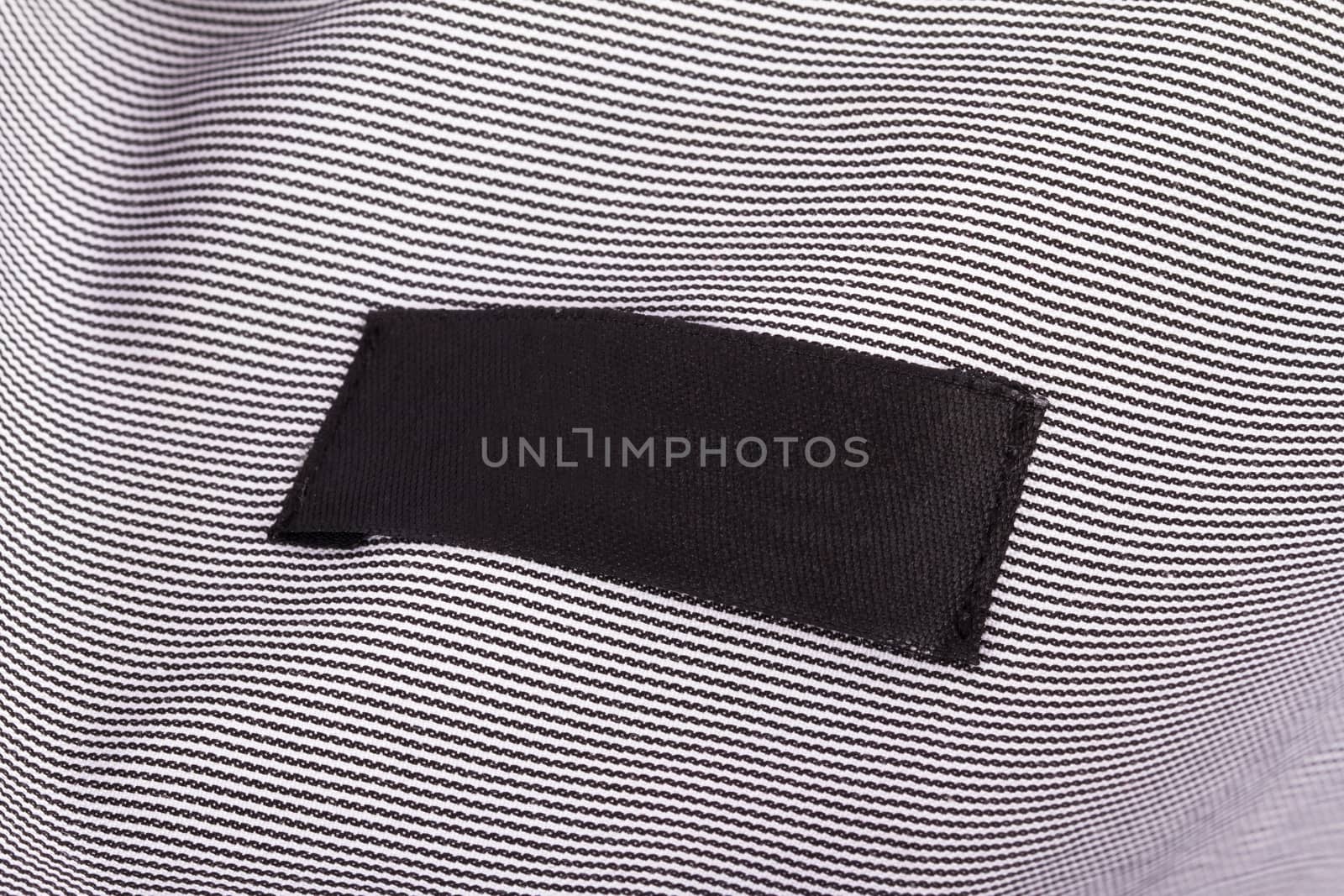 Close up view of blank black label in shirt.