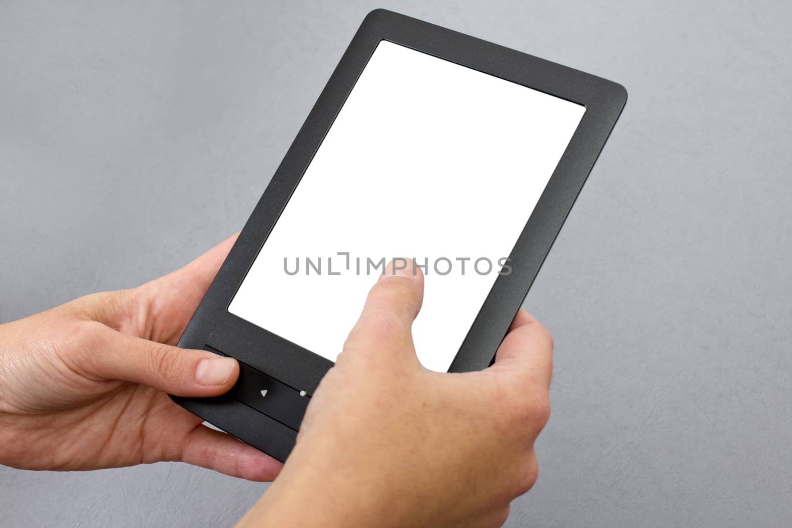 black new electronic book in mans hand on grey backgrounds