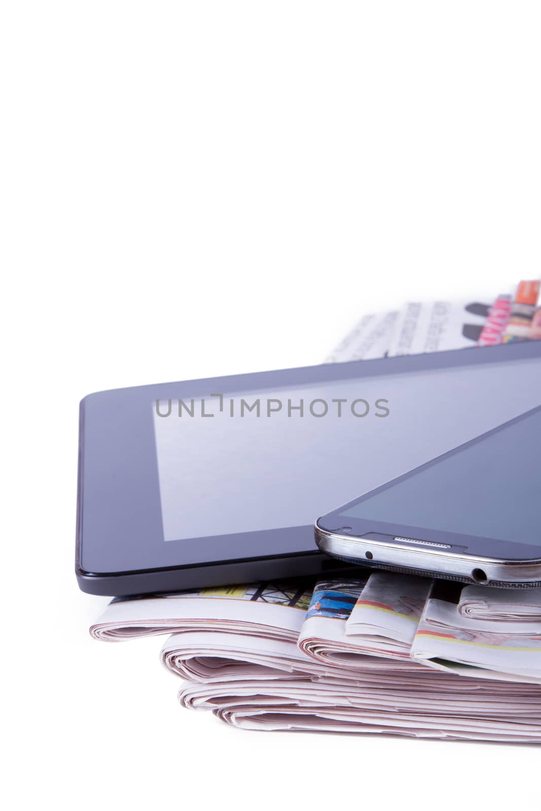 Stack of newspapers, tablet and mobile phone with blank screen, isolated on white background.