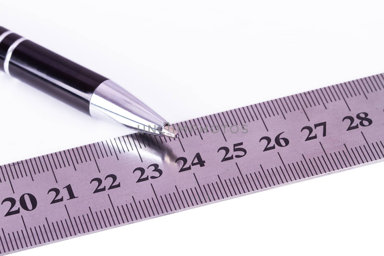 Close up view of pen and steel ruler for engineering drawing, isolated on white background.
