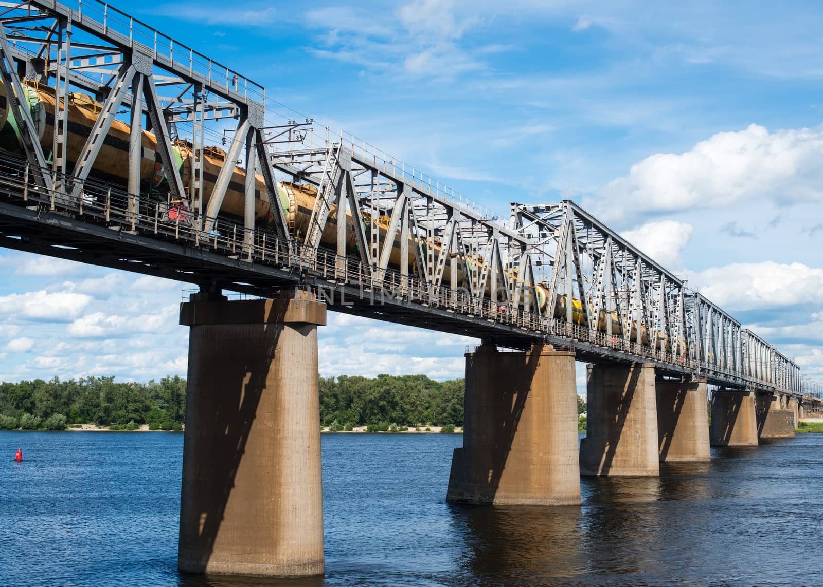 Petrivskiy railroad bridge in Kyiv across the Dnieper with freight train on it.